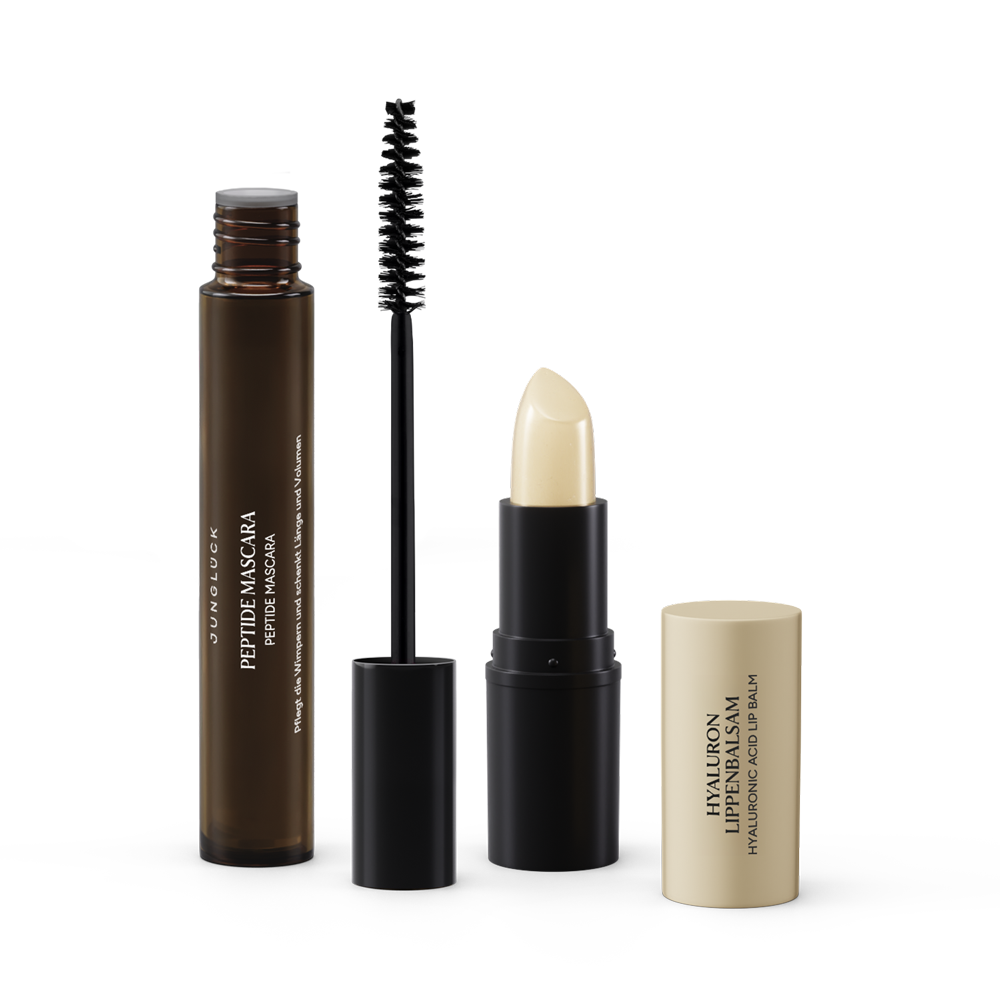Das Beauty Essentials Transparenz Set umfasst eine Peptidmascara in einer Braunglasflasche und einen Lippenbalsam in einem