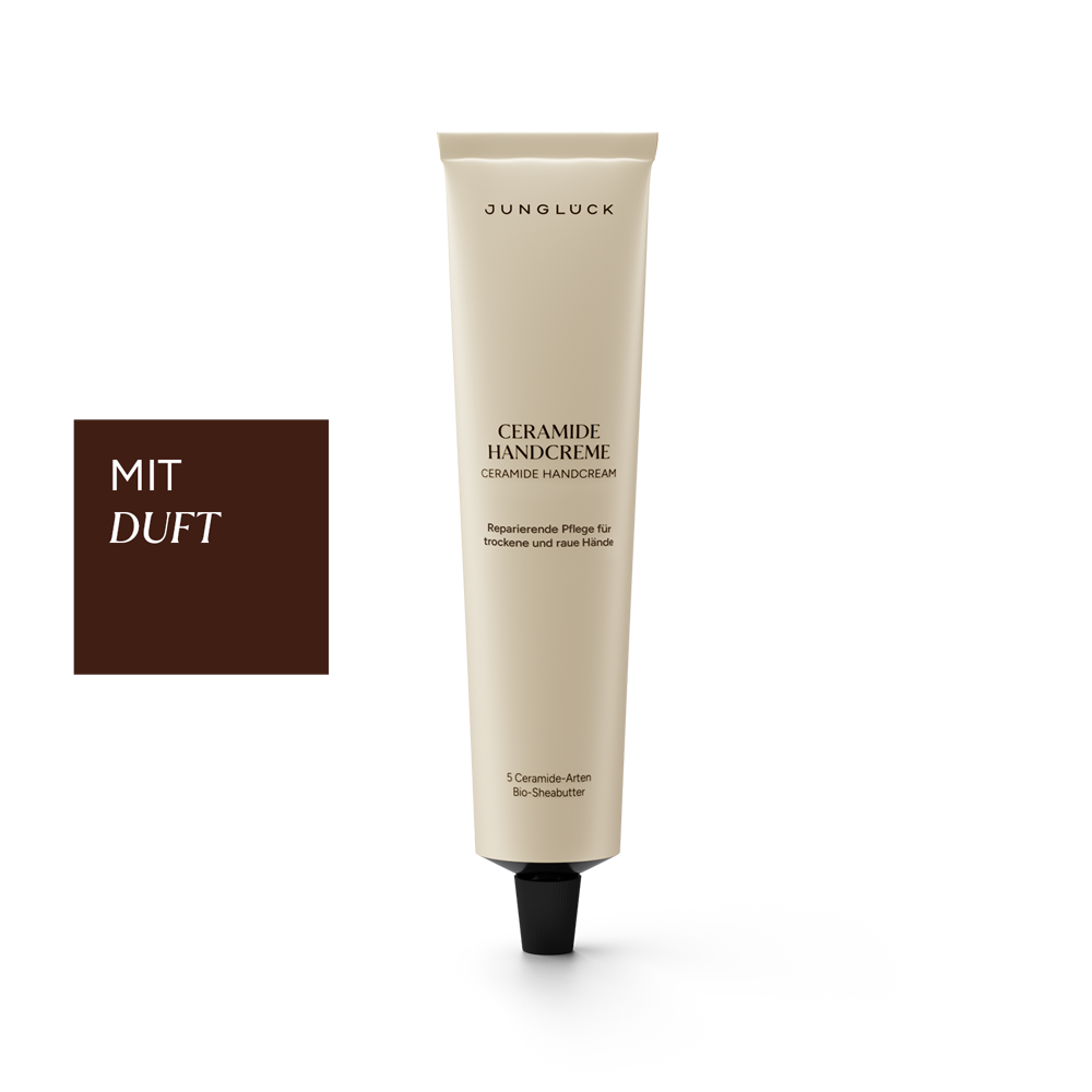 Beige tube of Junglück Ceramide Handcreme with black cap and German text detailing fragrance and care benefits.