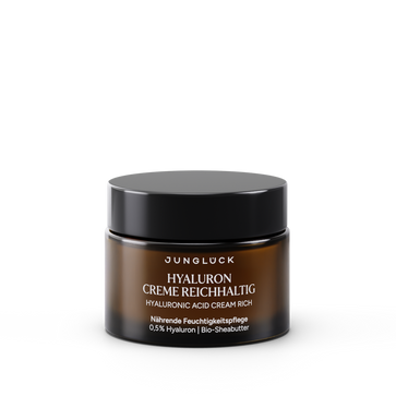 Brown glass jar of Junglück Hyaluron Creme Reichhaltig with black lid and white text, 50 ml size.