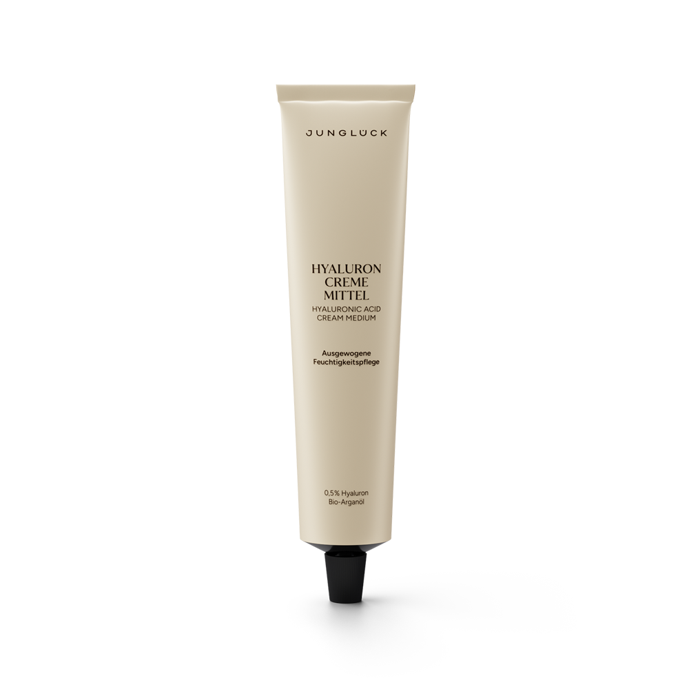 Beige squeeze tube of Junglück Hyaluron Creme Mittel with black cap and minimalist black text.