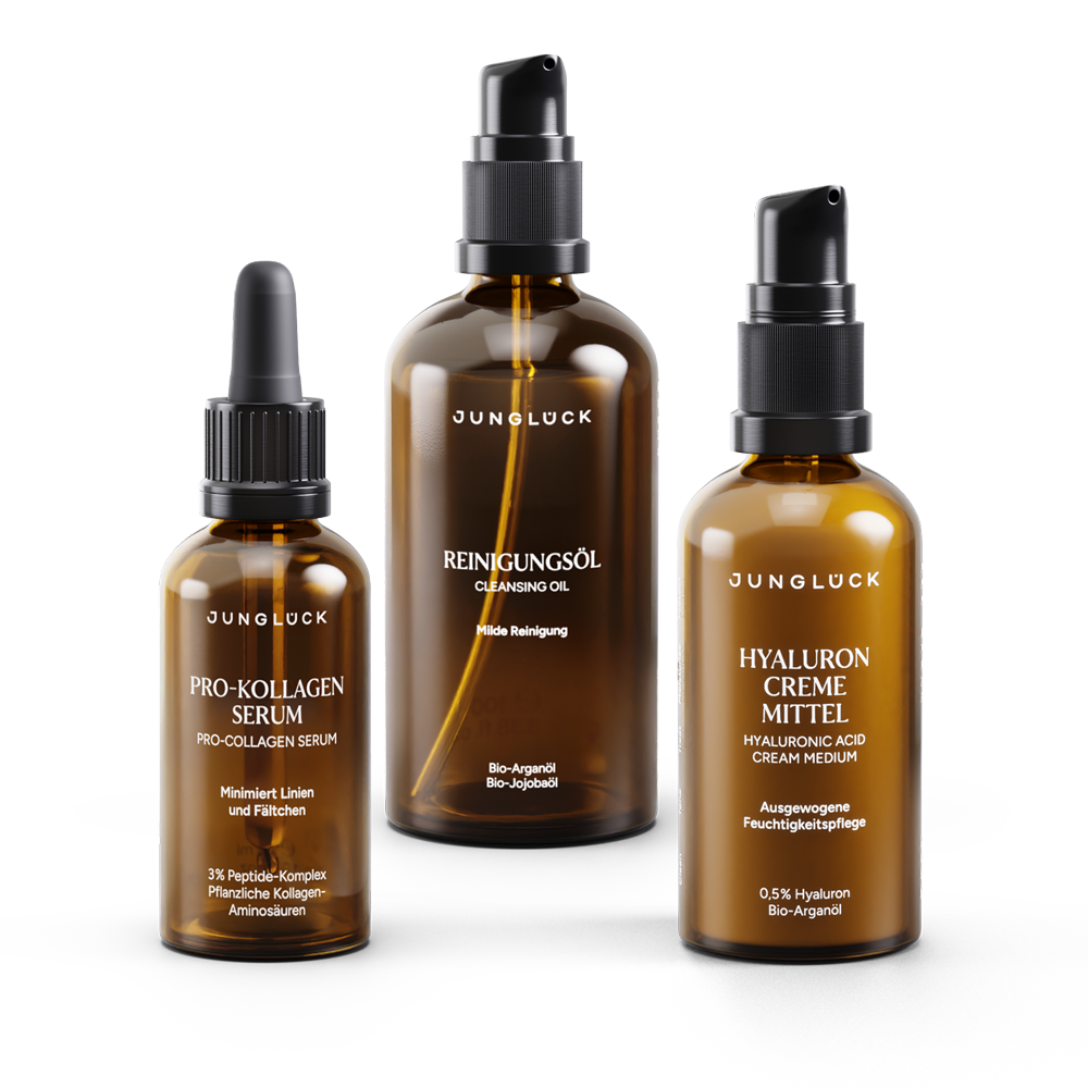 Three amber glass skincare bottles with black labels and black pump and dropper caps, labeled Pro-Kollagen Serum,.