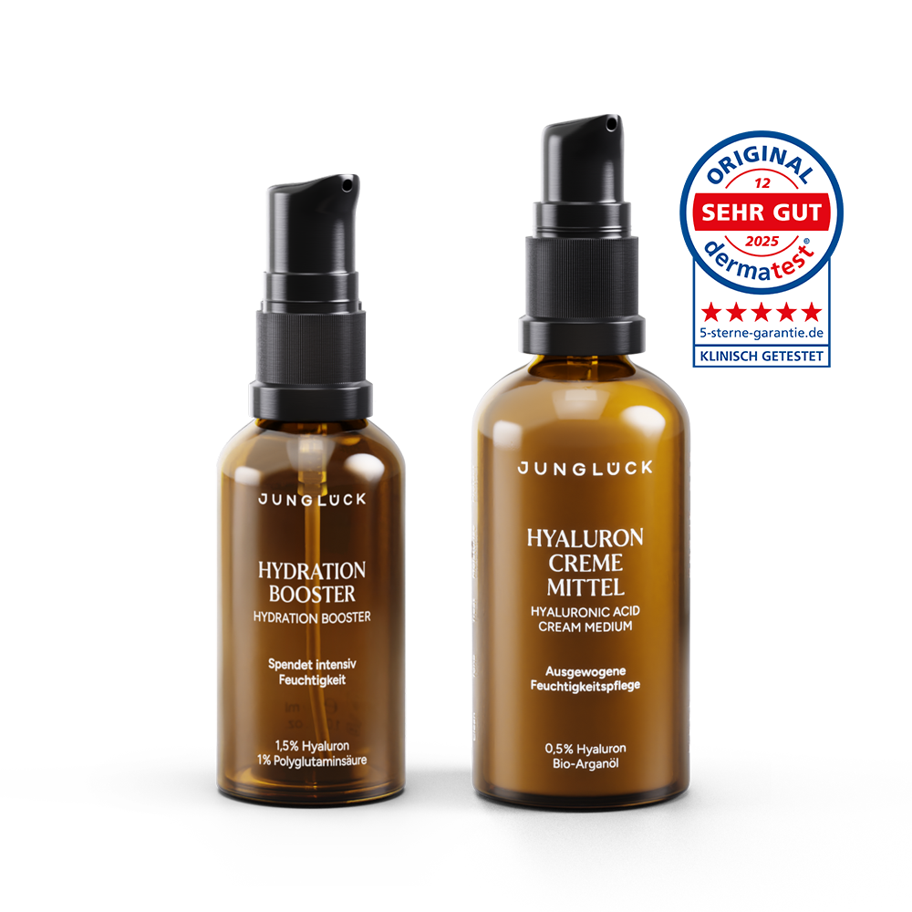Two amber glass bottles with black pump dispensers; one labeled Hydration Booster Serum, the other Hyaluron Cream Medium,.