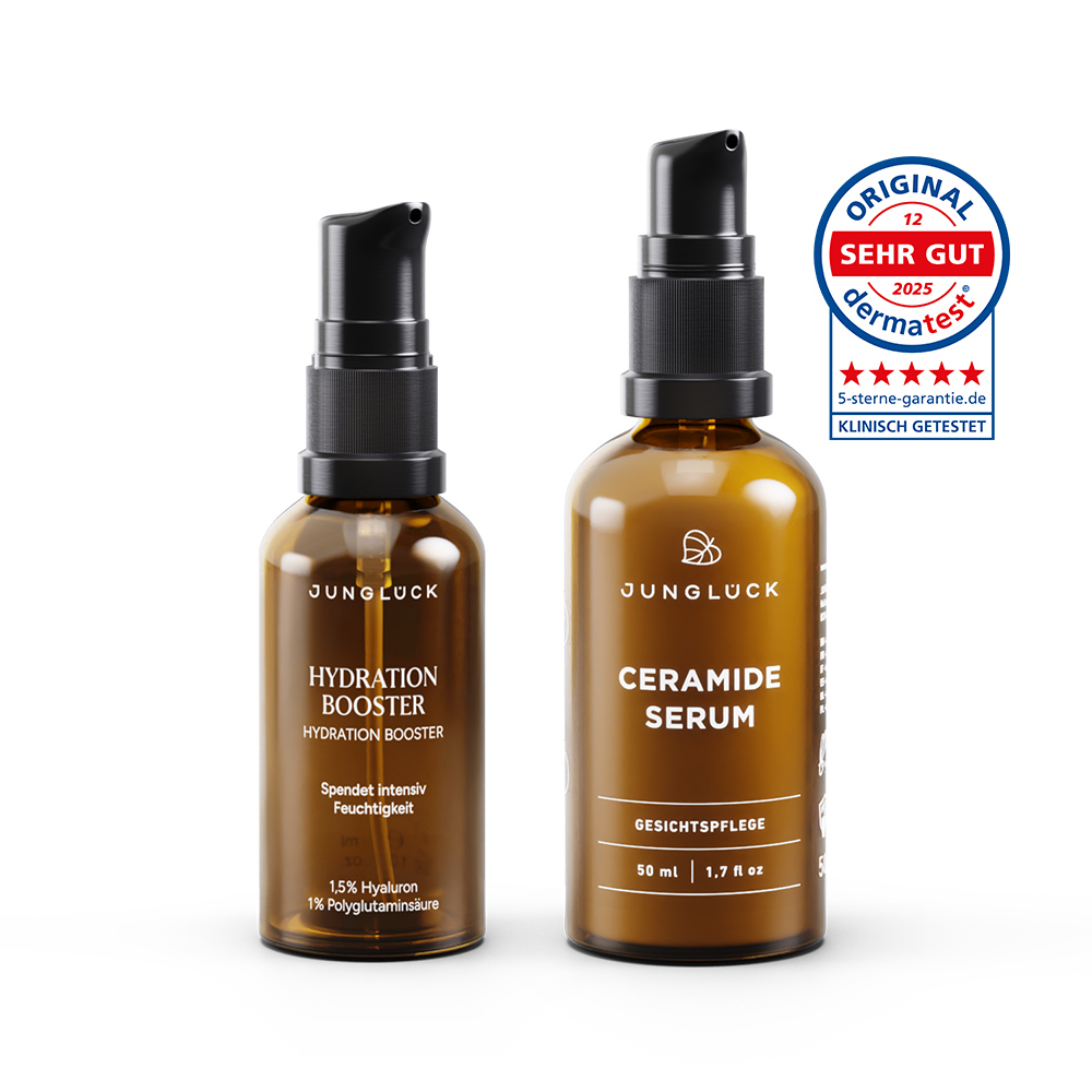 Two brown glass skincare bottles with black pump tops labeled Hydration Booster and Ceramide Serum by Junglock.