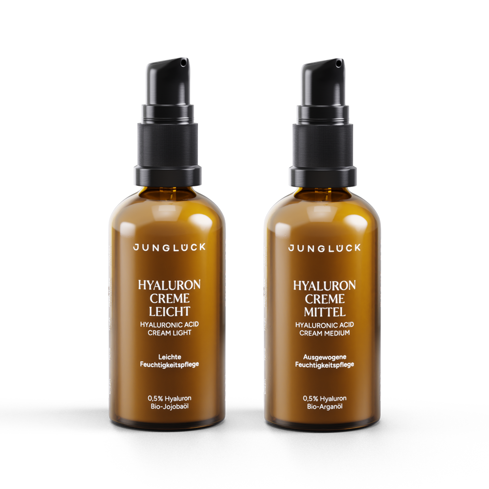 Two amber glass bottles of Sunlock Hyaluron face creams with black pump dispensers, labeled "Leicht" and "Mittel".