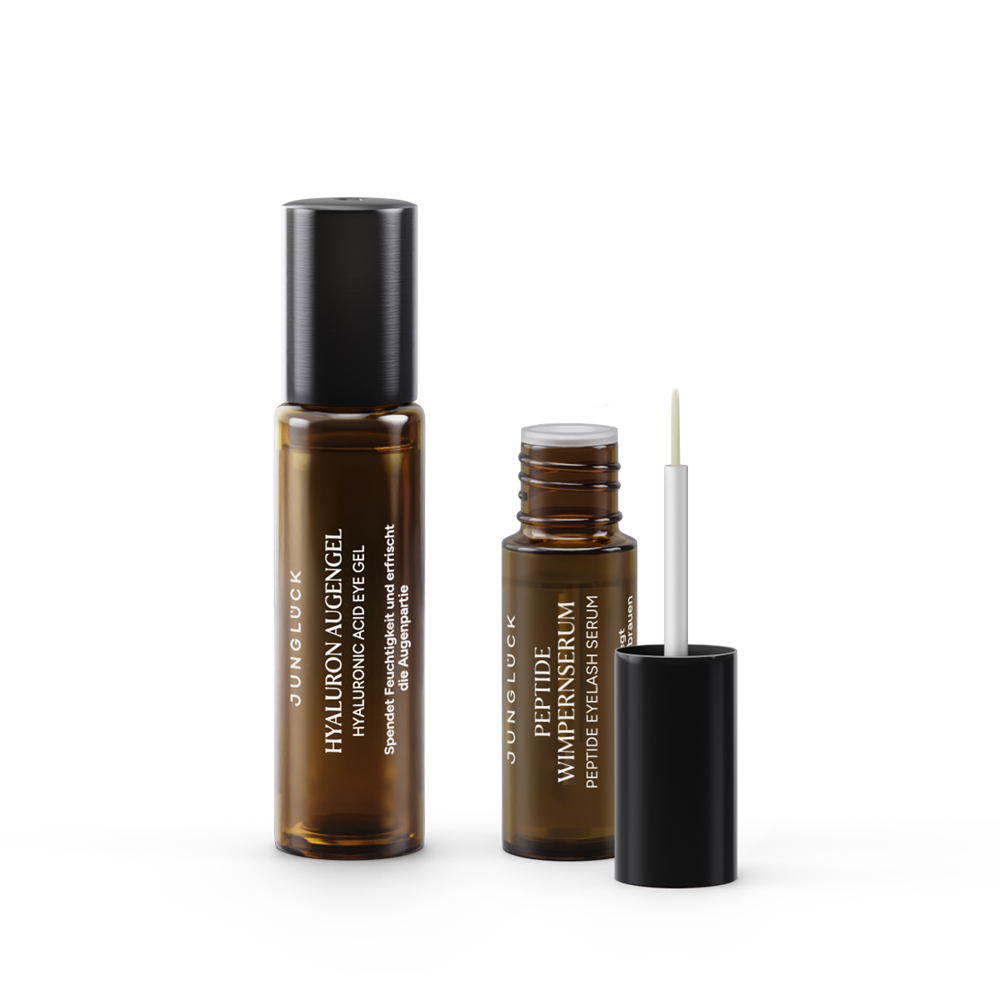 Zwei JUNGLÜCK Produkte: ein Hyaluron-Augengel und ein Peptid-Wimpernserum in Braunglasflaschen, jeweils mit Pipette.