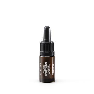 Small amber glass dropper bottle of Vitamin C Sensitiv Serum with black cap and white text label.